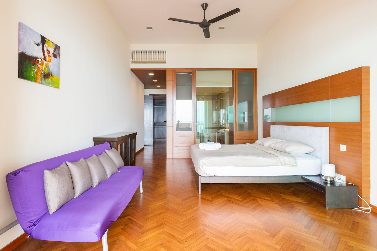 Master bedroom with a king bed, sofa bed and ensuite access